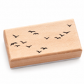 Rectangular wooden flying bird flock stamp on a white background